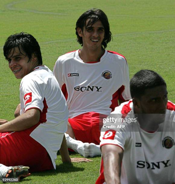 Costa Rican footballers Bryan Ruiz , Cristian Montero and Dario Delgado rest after a training session in the province of Alajuela, some 20 km west...
