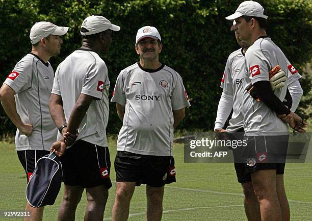 Costa Rican football team coach Brazilian Rene de Simoes speaks with his assistants after a training session in the province of Alajuela, some 20 km...