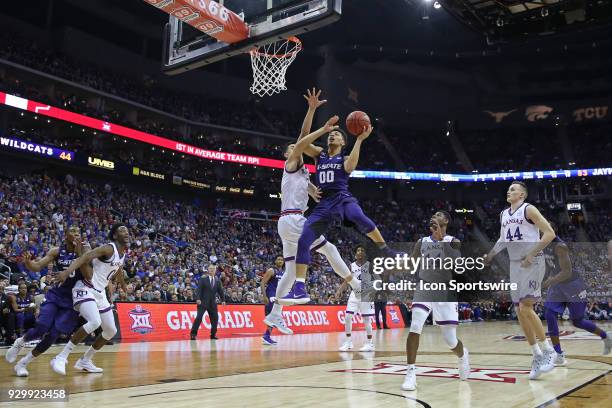 Kansas State Wildcats guard Mike McGuirl draws the foul and makes the basket with 12:33 left in the second half of a semifinal game in the Big 12...