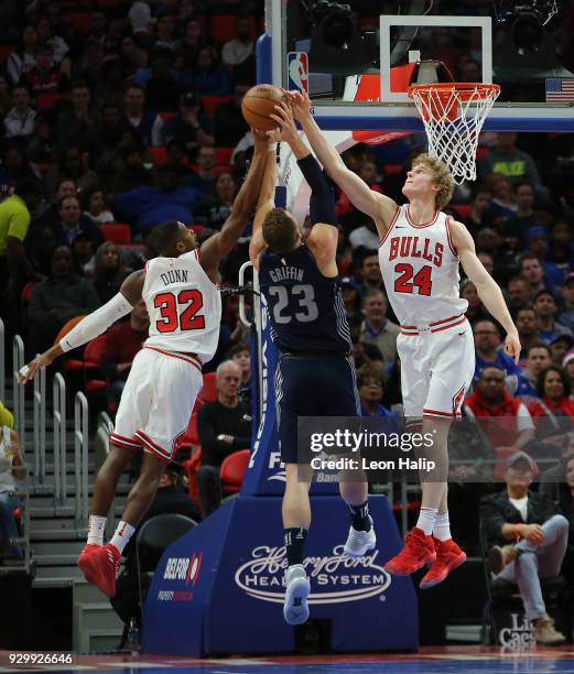 Blake Griffin of the Detroit Pistons drives the ball to the basket as Kris Dunn and Lauri Markkanen of the Chicago Bulls defend during the first half...