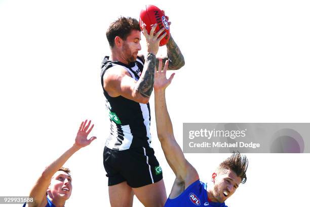 Jeremy Howe of the Magpies marks the ball against Marcus Bontempelli of the Bulldogs during the JLT Community Series AFL match between Collingwood...