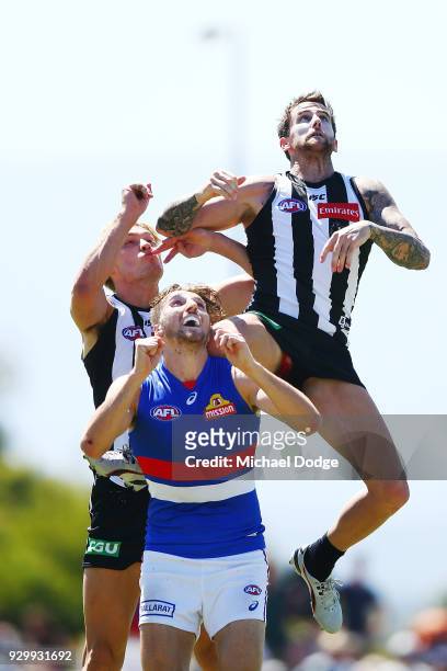 Jeremy Howe of the Magpies marks the ball against Marcus Bontempelli of the Bulldogs during the JLT Community Series AFL match between Collingwood...