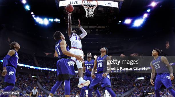 All five Wildcats on the floor watch Kansas' Malik Newman get an easy bucket during the first half on Friday, March 9, 2018 during the Big 12...