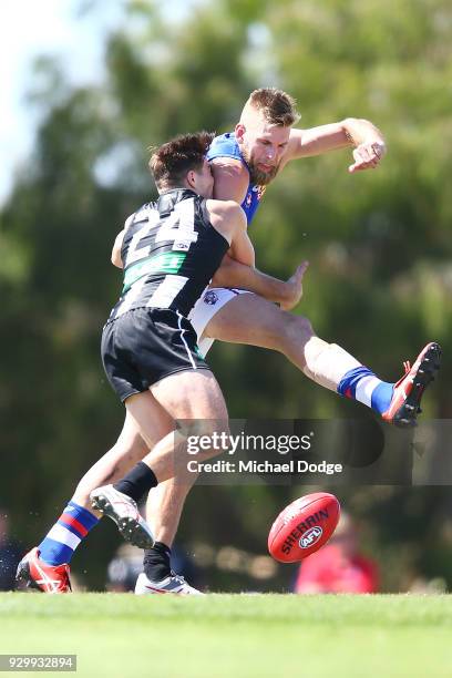 Josh Thomas of the Magpies tackles Jackson Trengove of the Bulldogs during the JLT Community Series AFL match between Collingwood Magpies and the...