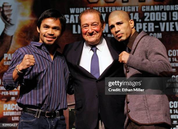 Boxer Manny Pacquiao, boxing promoter Bob Aru and WBO welterweight champion Miguel Cotto pose during the final news conference for their bout at the...