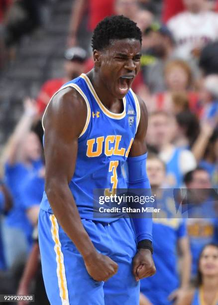 Aaron Holiday of the UCLA Bruins reacts after hitting a 3-pointer against the Arizona Wildcats during a semifinal game of the Pac-12 basketball...