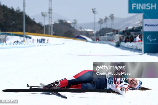 Vilde Nilsen of Norway collapses after crossing the finish line during the Women's 6 km Standing Biathlon competition at Alpensia Biathlon Centre on...