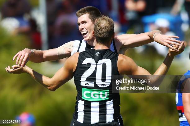 Mason Cox of the Magpies celebrates a goal with Ben Reid during the JLT Community Series AFL match between Collingwood Magpies and the Western...