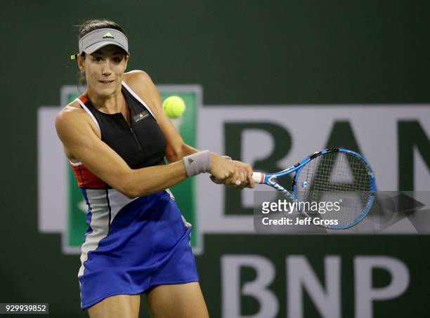 Garbine Muguruza of Spain returns a backhand to Sachia Vickery during the BNP Paribas Open at the Indian Wells Tennis Garden on March 9, 2018 in...