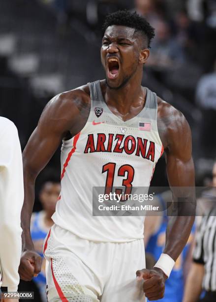 Deandre Ayton of the Arizona Wildcats celebrates on the court late in overtime during a semifinal game of the Pac-12 basketball tournament against...