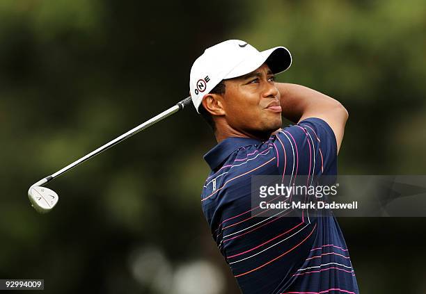 Tiger Woods of the USA plays an approach shot on the 18th hole during round one of the 2009 Australian Masters at Kingston Heath Golf Club on...