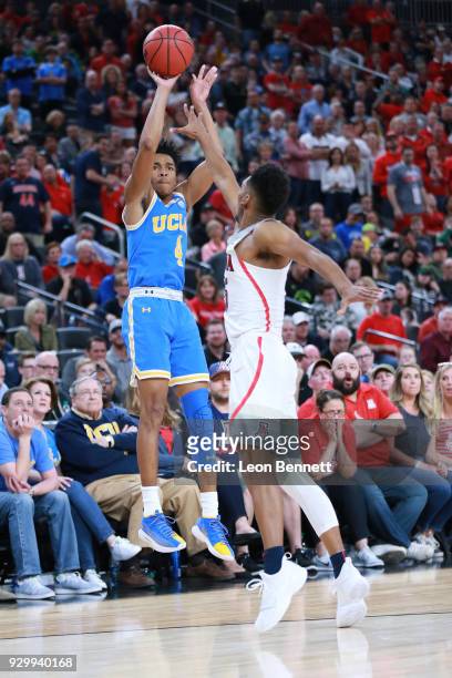 Jaylen Hands of the UCLA Bruins shoots the three over Allonzo Trier of the Arizona Wildcats during a semifinal game of the Pac-12 basketball...