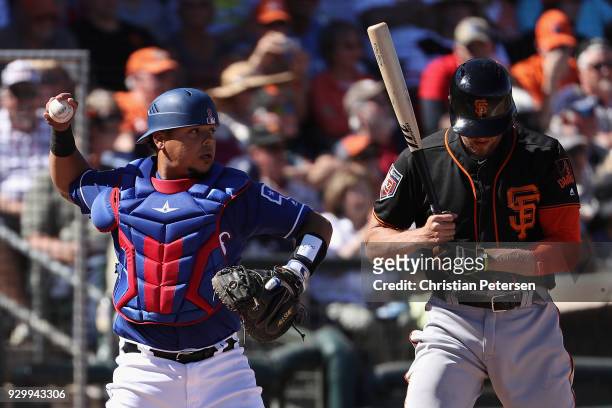 Catcher Juan Centeno of the Texas Rangers during the spring training game against the San Francisco Giants at Surprise Stadium on March 5, 2018 in...