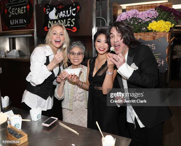 Erin Sutton and Paul Stanley of KISS pose with Chef Helene "Mama" An and daughter Catherine An of House of An attend "An Iconic Affair" hosted by...