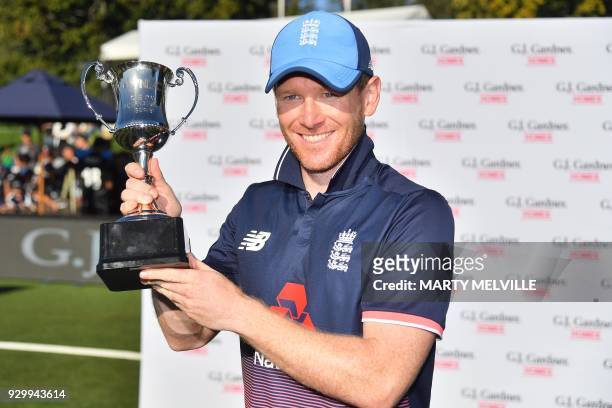 England's captain Eoin Morgan holds the One Day cup after winning the One Day series following the fifth and final ODI cricket match between New...