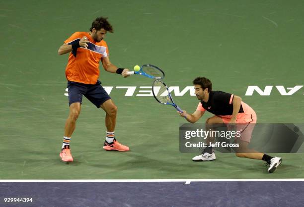 Feliciano Lopez and Marc Lopez of Spain come together while returning to Juan Martin Del Potro of Argentina and Grigor Dimitrov of Bulgaria during...