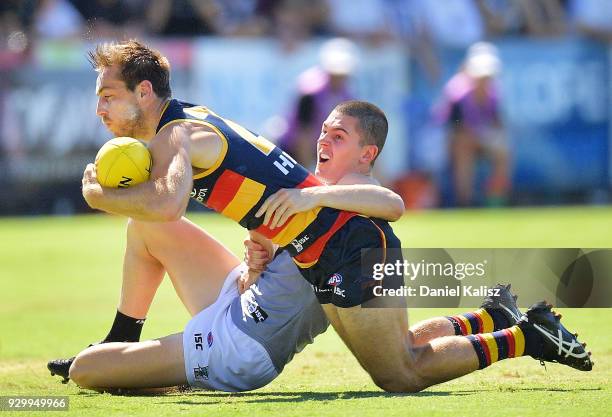 Richard Douglas of the Crows is tackled by Darcy Byrne-Jones of the Power during the JLT Community Series AFL match between Port Adelaide Power and...