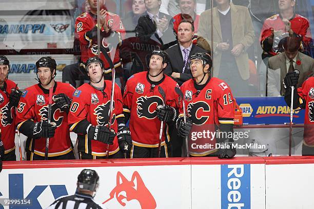 Assistant Coach Dave Lowry of the Calgary Flames and his players look up at the scoreboard during their game against the Detroit Red Wings on October...