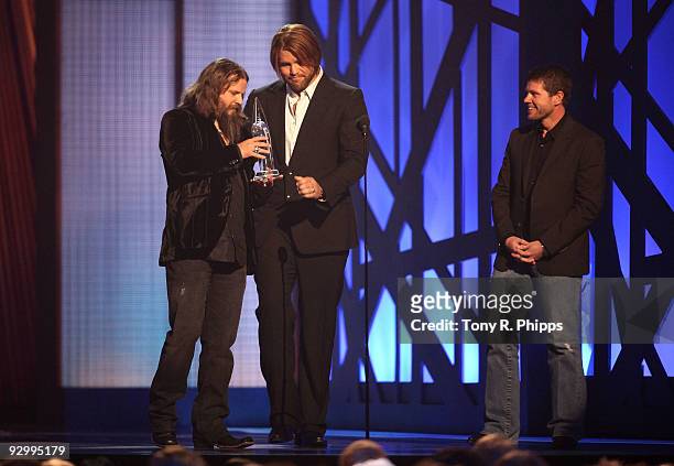 Musician Jamey Johnson accepts the award for Song of the Year with James Otto and Lee Thomas Miller onstage during the 43rd Annual CMA Awards at the...