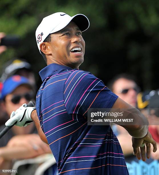 Tiger Woods of the US's hand slips off the club after a spectator disturbed his swing during the first round of the Australian Masters at the...