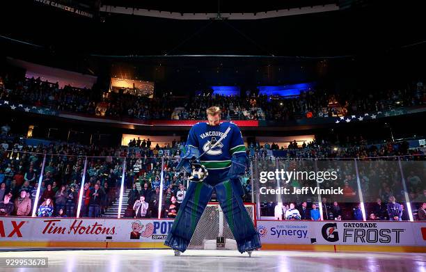 Anders Nilsson of the Vancouver Canucks listens to the national anthem before their NHL game against the Minnesota Wild at Rogers Arena March 9, 2018...