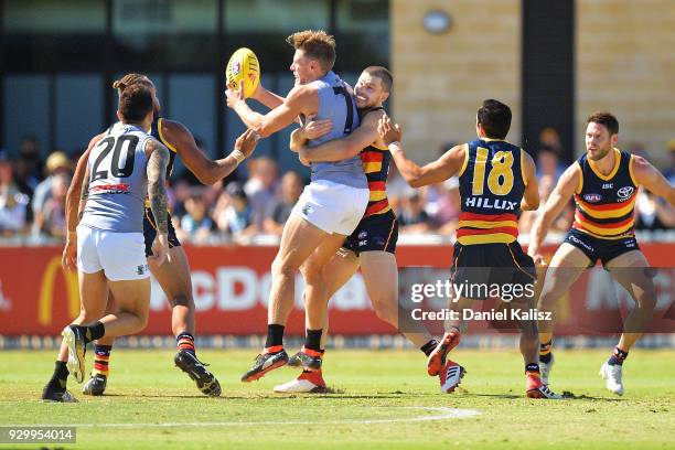 Bryce Gibbs of the Crows tackles Brad Ebert of the Power during the JLT Community Series AFL match between Port Adelaide Power and the Adelaide Crows...