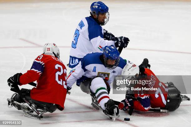 Rolf Einar Pedersen and Ola Oiseth of Norway battles for the puck with Greg Leperdi and Florian Planker of Italy in the Ice Hockey Preliminary Round...