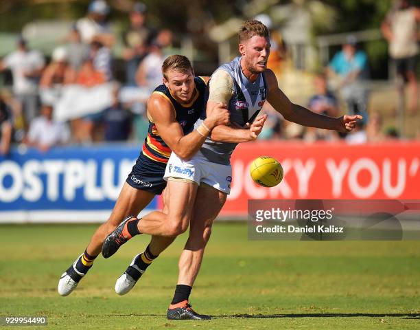 Daniel Talia of the Crows tackles Brad Ebert of the Power during the JLT Community Series AFL match between Port Adelaide Power and the Adelaide...