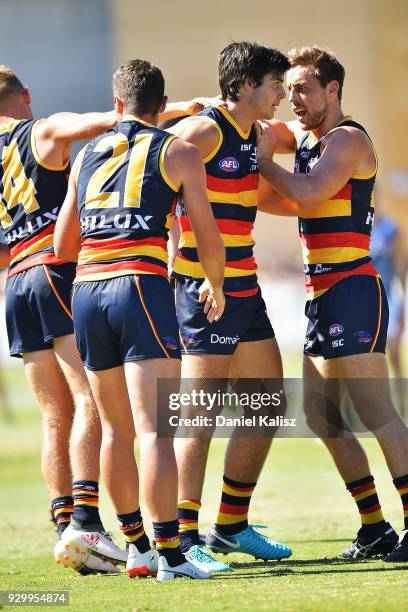 Darcy Fogarty of the Crows celebrates with his team mates after kicking a goal during the JLT Community Series AFL match between Port Adelaide Power...