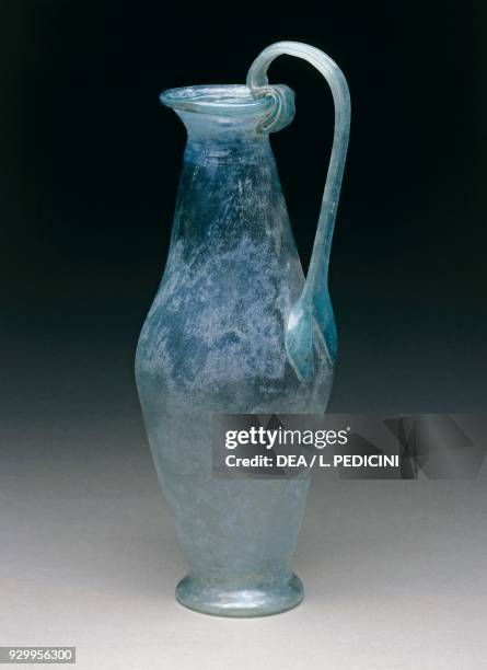 Light green glass bottle with a ribbon-shaped handle raised above the lip, Pompeii, Campania, Italy. Roman civilisation, 1st century AD.