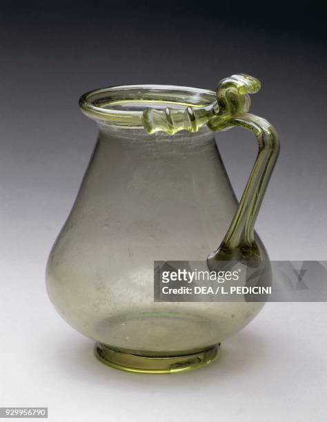 Light green glass jug with pear-shaped body, everted rim and vertical ribbon-shaped handle, Pompeii, Campania, Italy. Roman civilisation, 1st century...