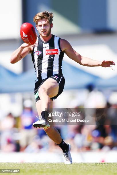 Sam Murray of the Magpies kicks the ball during the JLT Community Series AFL match between Collingwood Magpies and the Western Bulldogs at Ted...