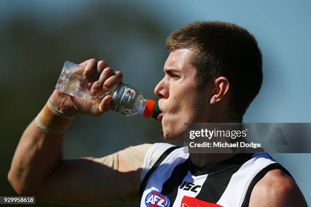 Mason Cox of the Magpies hydrates with a drink during the JLT Community Series AFL match between Collingwood Magpies and the Western Bulldogs at Ted...