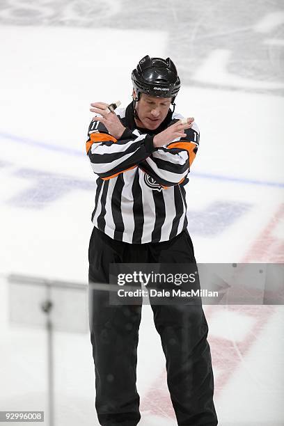 Referee Kelly Sutherland makes a call of Interference during the game between the Detroit Red Wings and the Calgary Flames on October 31, 2009 at the...