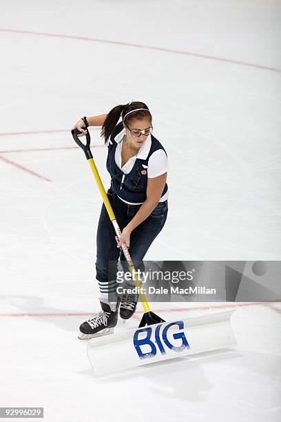 An Ice Girl cleans the ice during a break in play between the Detroit Red Wings and the Calgary Flames on October 31, 2009 at the Pengrowth...