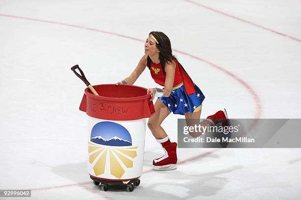 An Ice Girl pushes a trash container and shovel across the ice during a break in play between the Detroit Red Wings and the Calgary Flames on October...