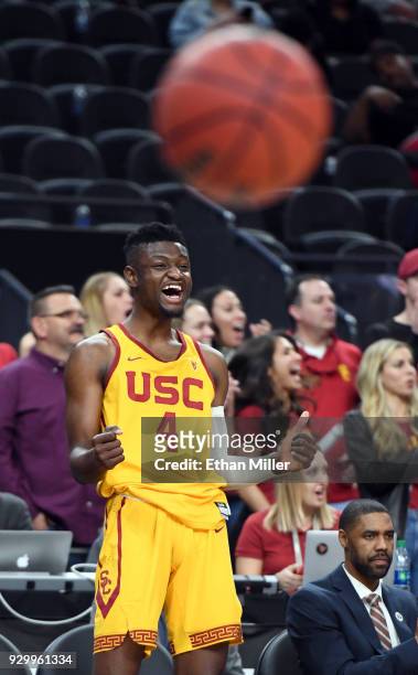 Chimezie Metu of the USC Trojans celebrates on the bench late in a semifinal game of the Pac-12 basketball tournament against the Oregon Ducks at...