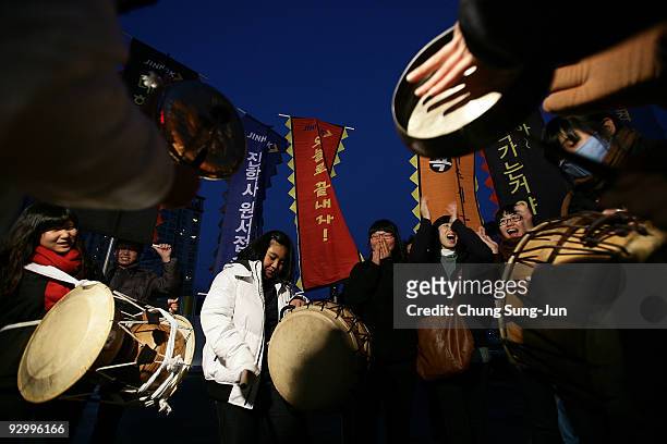 South Korean high school girls cheer on their senior schoolmates taking the College Scholastic Ability Test at a school on November 12, 2009 in...