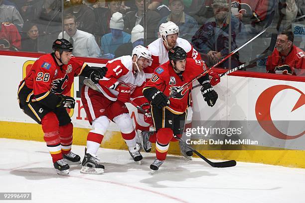 Daniel Cleary and Niklas Kronwall of the Detroit Red Wings skate against Robyn Regehr and Curtis Glencross of the Calgary Flames during their game on...