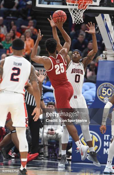 Alabama forward Braxton Key shoots over Auburn forward Horace Spencer in the first half during a Southeastern Conference Basketball Tournament game...