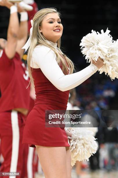 An Alabama cheerleader performs during a Southeastern Conference Basketball Tournament game between Auburn and Alabama on March 09 at Scottrade...