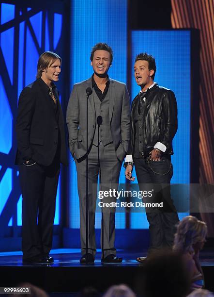 Musicians Brian Bandas, Eric Gunderson and Stephen Barker Liles of Love and Theft performs onstage during the 43rd Annual CMA Awards at the Sommet...