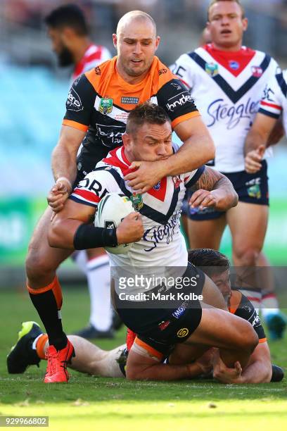 R08 of the Roosters is tackled during the round one NRL match between the Wests Tigers and the Sydney Roosters at ANZ Stadium on March 10, 2018 in...