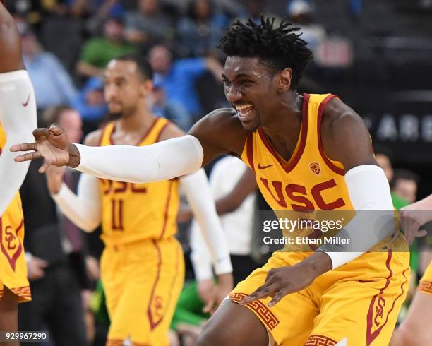 Jonah Mathews of the USC Trojans celebrates on the court after teammate Elijah Stewart hit a 3-pointer against the Oregon Ducks during a semifinal...