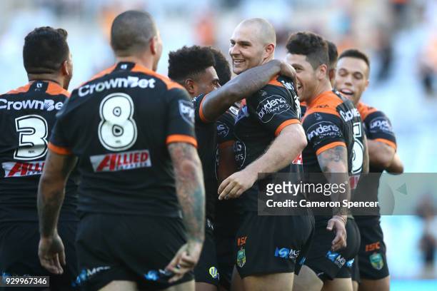 Robert Rochow of the Tigers celebrates with team mates after winning the round one NRL match between the Wests Tigers and the Sydney Roosters at ANZ...