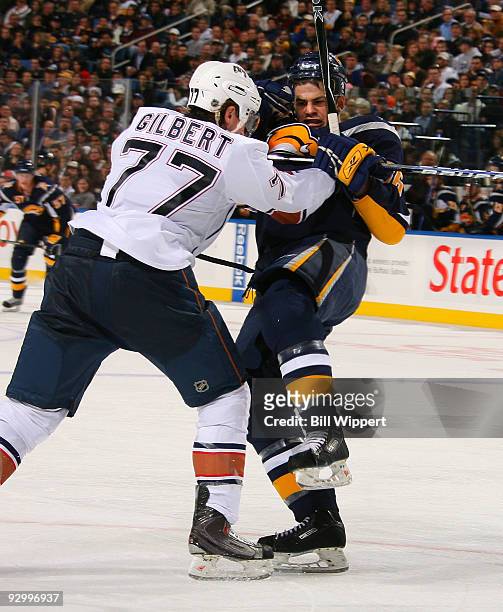 Patrick Kaleta of the Buffalo Sabres tries to get away from the check of Tom Gilbert of the Edmonton Oilers on November 11, 2009 at HSBC Arena in...