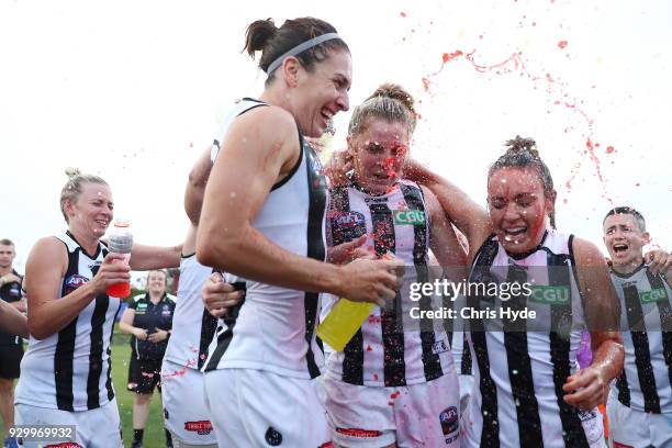 Magpies celebrate winning the round six AFLW match between the Brisbane Lions and the Collingwood Magpies at Moreton Bay Sports Complex on March 10,...