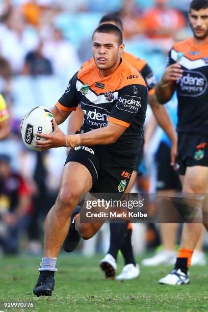 Tuimoala Lolohea of the Tigers runs the ball during the round one NRL match between the Wests Tigers and the Sydney Roosters at ANZ Stadium on March...