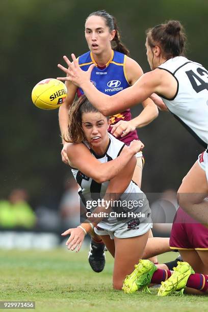 Chloe Molloy of the Magpies handballs during the round six AFLW match between the Brisbane Lions and the Collingwood Magpies at Moreton Bay Sports...