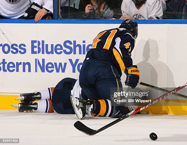 Liam Reddox of the Edmonton Oilers lays on the ice after he was injured from a third period check into the boards by Clarke MacArthur of the Buffalo...